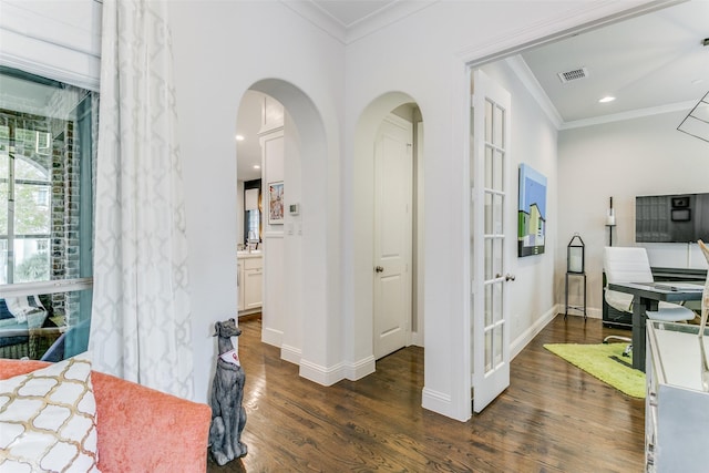 hall with dark hardwood / wood-style floors and ornamental molding