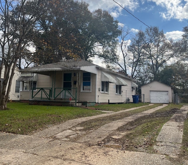 bungalow-style house with a garage, an outbuilding, and a front yard