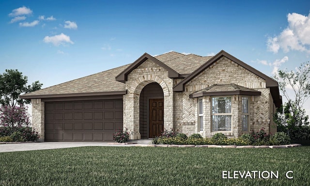 view of front of property with a front yard and a garage