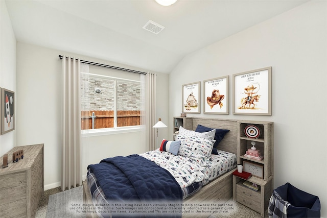 carpeted bedroom featuring lofted ceiling