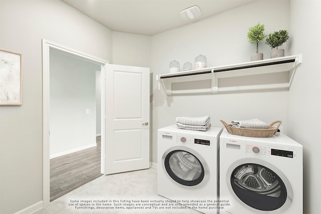 clothes washing area with separate washer and dryer