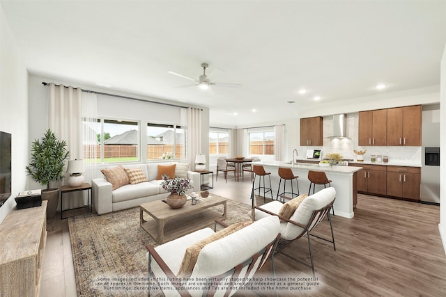 living room with dark wood-type flooring, sink, and ceiling fan