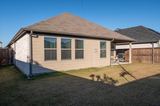 rear view of house featuring a yard