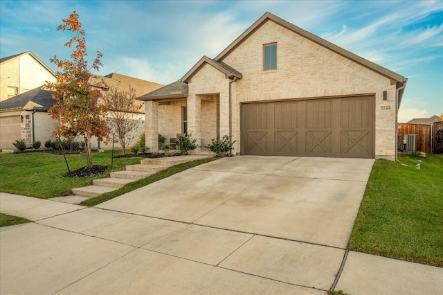 view of front of property with a front yard, a garage, and central AC unit