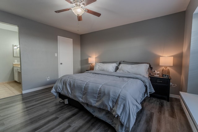 bedroom with ensuite bath, ceiling fan, and dark hardwood / wood-style flooring