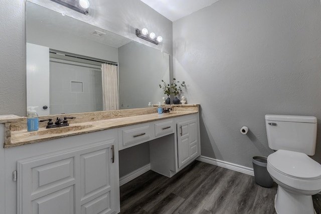 bathroom with toilet, walk in shower, wood-type flooring, and vanity