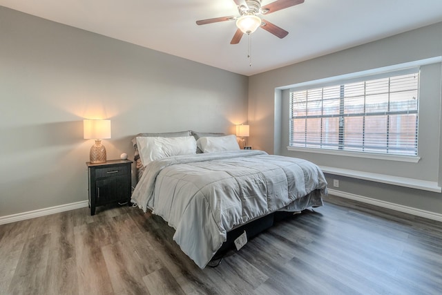 bedroom with dark wood-type flooring and ceiling fan