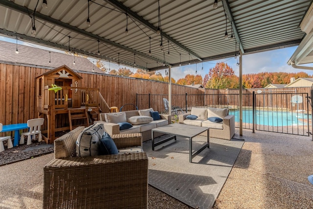 view of patio featuring a playground, an outdoor hangout area, and a fenced in pool