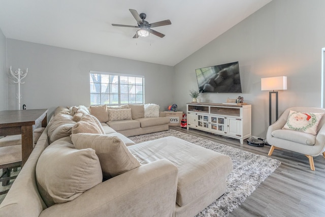 living room featuring vaulted ceiling, light wood-type flooring, and ceiling fan