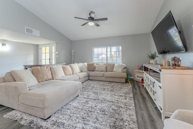 living room with dark wood-type flooring, french doors, ceiling fan, and vaulted ceiling