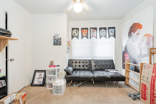 living area with carpet flooring and ceiling fan