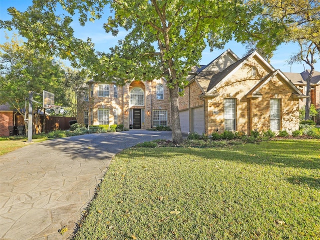 front facade featuring a garage and a front lawn