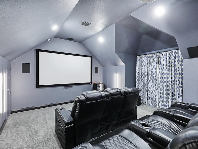 home theater room with light colored carpet, lofted ceiling, and a textured ceiling