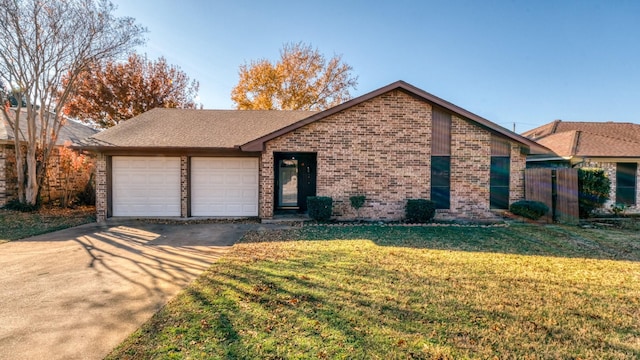 view of front of property featuring a front lawn and a garage