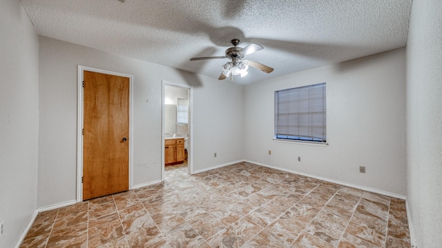 spare room with ceiling fan and a textured ceiling