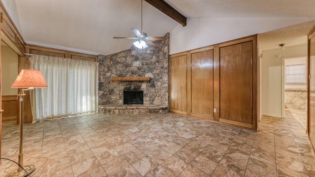 unfurnished living room with ceiling fan, a fireplace, lofted ceiling with beams, and a textured ceiling