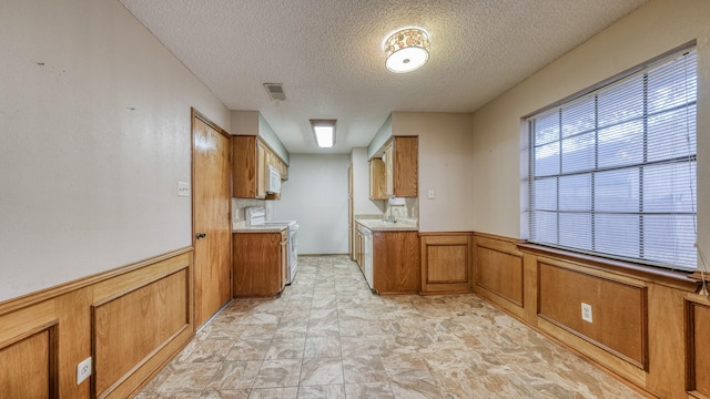 kitchen featuring sink, white electric range, and a textured ceiling