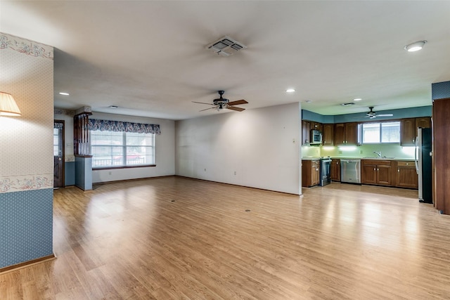 unfurnished living room with ceiling fan and light hardwood / wood-style floors