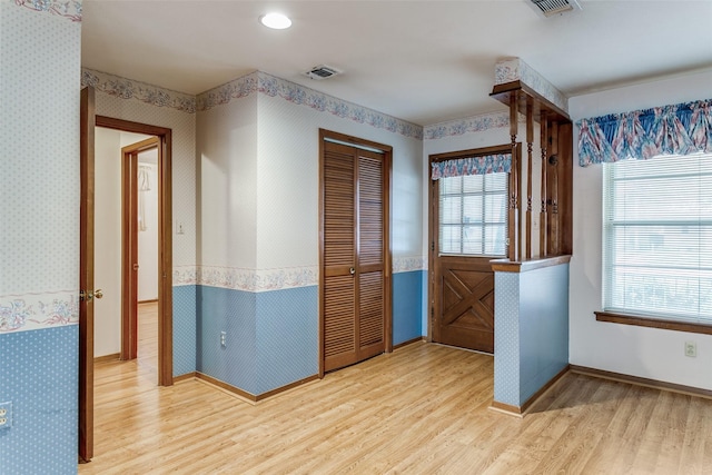 entrance foyer with hardwood / wood-style floors and a wealth of natural light