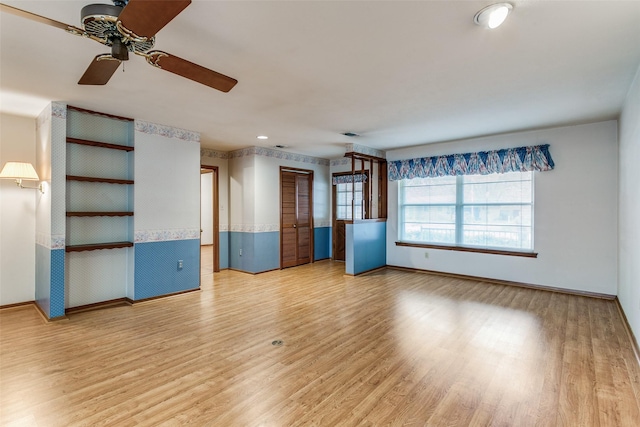 unfurnished living room with hardwood / wood-style floors and ceiling fan