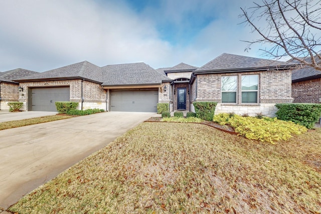 view of front of home featuring a garage and a front lawn