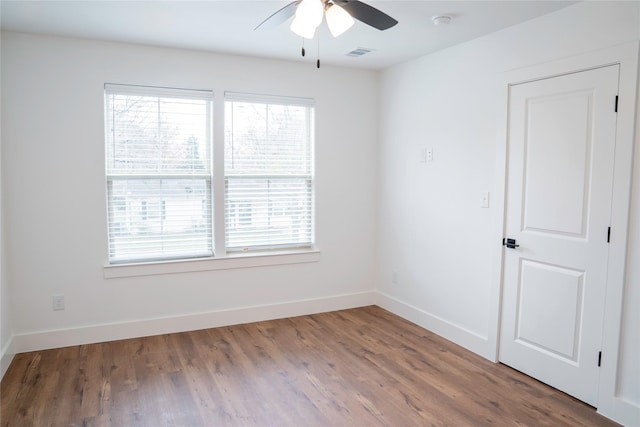 unfurnished room with ceiling fan and hardwood / wood-style flooring