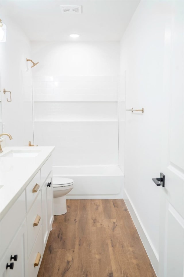 full bathroom featuring hardwood / wood-style flooring, toilet, vanity, and bathing tub / shower combination