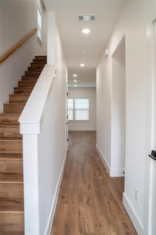 hallway with wood-type flooring