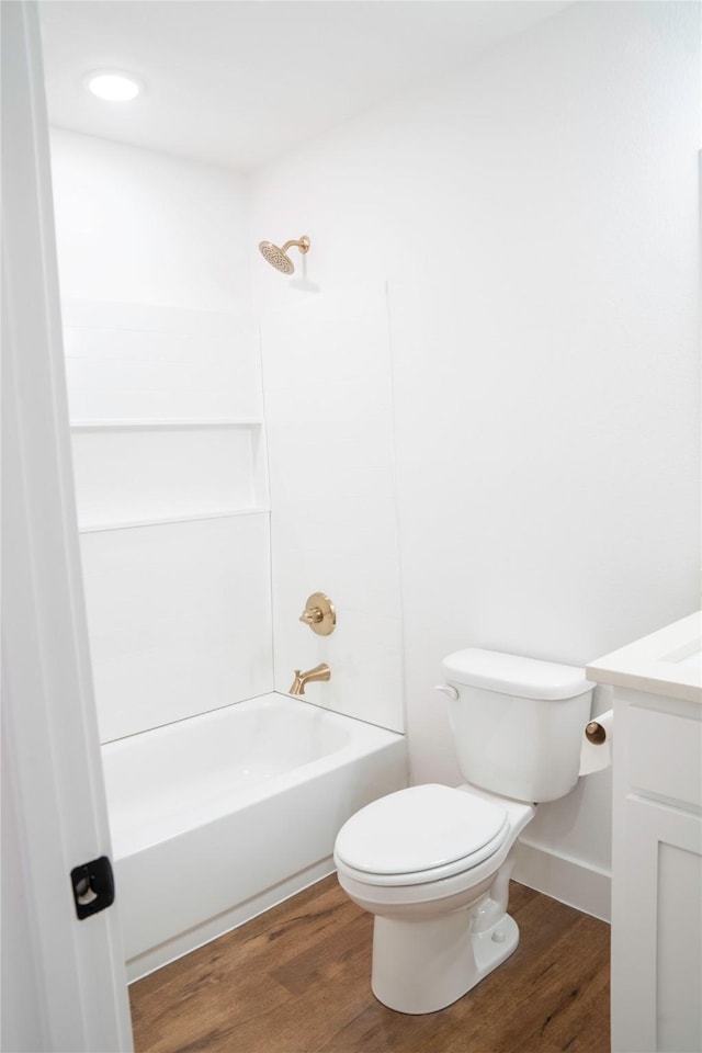 full bathroom featuring wood-type flooring, toilet, vanity, and bathing tub / shower combination