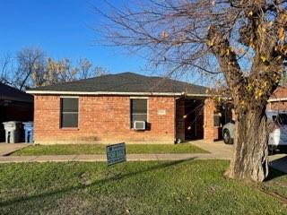 rear view of house featuring a lawn