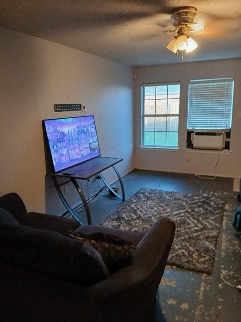 living room featuring a textured ceiling, ceiling fan, and cooling unit