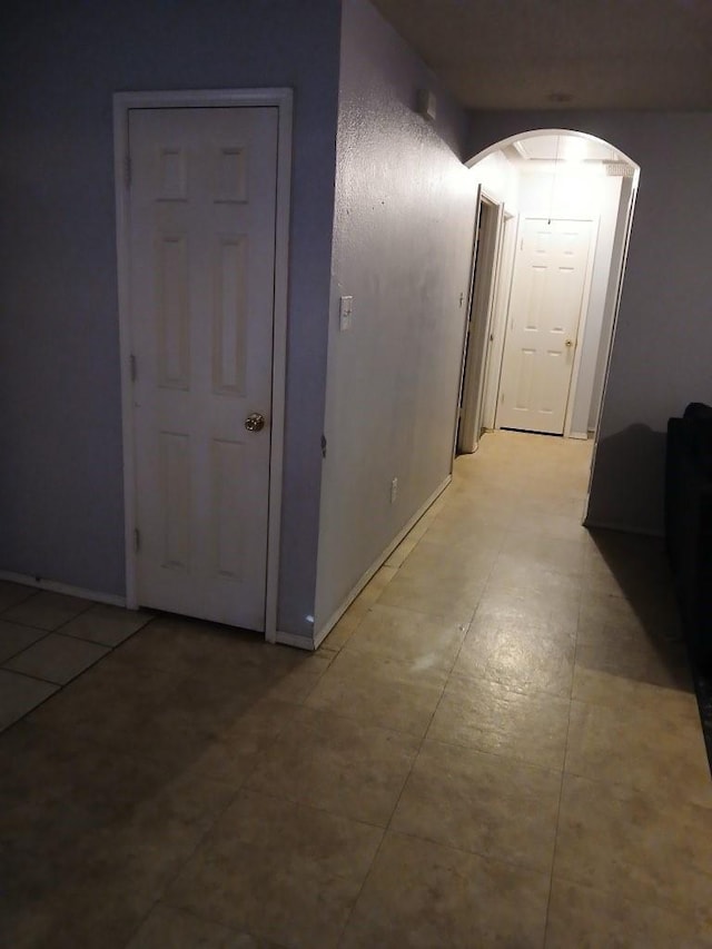 hall featuring light tile patterned flooring