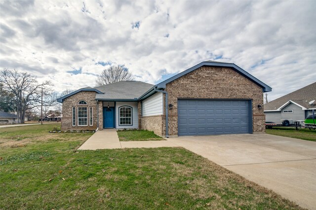 ranch-style house with a garage and a front lawn