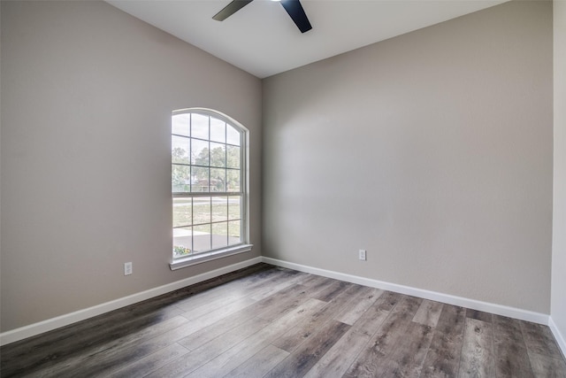 empty room with hardwood / wood-style flooring, ceiling fan, and lofted ceiling