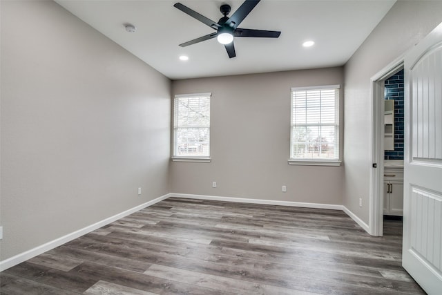 unfurnished room featuring ceiling fan and dark hardwood / wood-style flooring