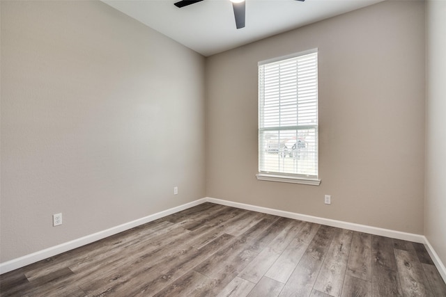 spare room featuring hardwood / wood-style flooring and ceiling fan