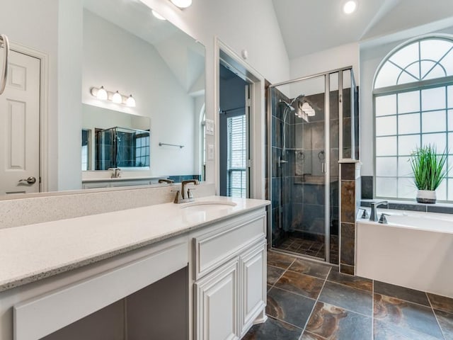 bathroom featuring vanity, plus walk in shower, and vaulted ceiling