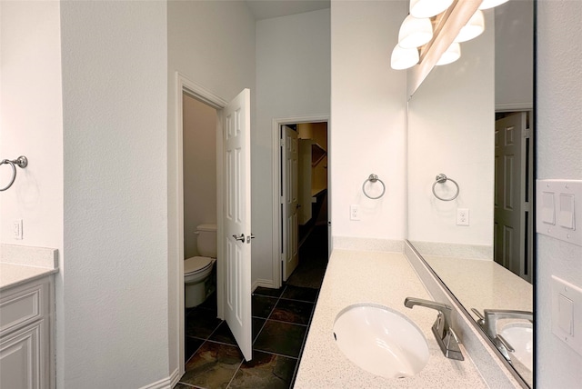 bathroom with toilet and vanity