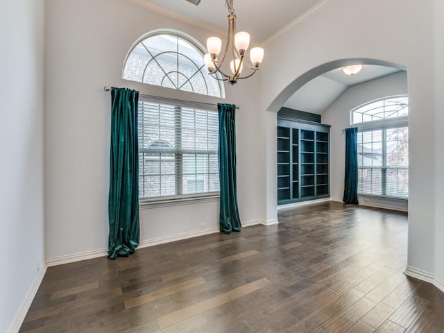 unfurnished room with ornamental molding, dark hardwood / wood-style floors, and a chandelier