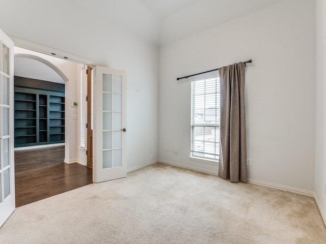 carpeted empty room with french doors