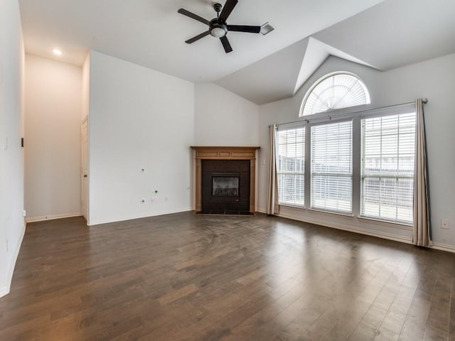 unfurnished living room with dark hardwood / wood-style flooring, vaulted ceiling, a tile fireplace, and ceiling fan