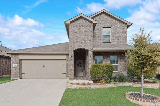 view of front facade with a front yard and a garage