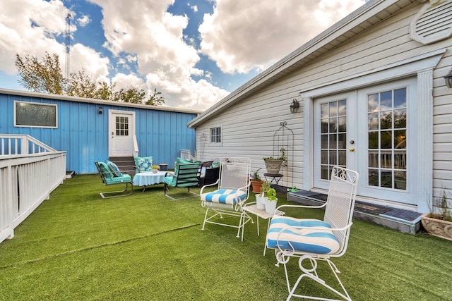 rear view of house featuring french doors and a yard