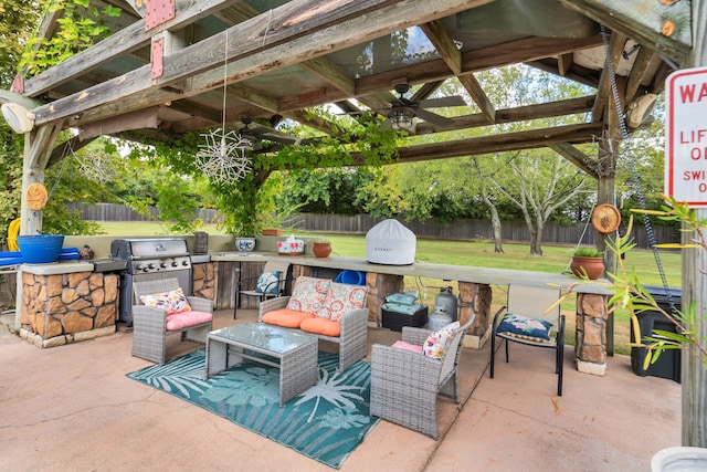 view of patio / terrace featuring an outdoor kitchen, area for grilling, a pergola, ceiling fan, and an outdoor living space