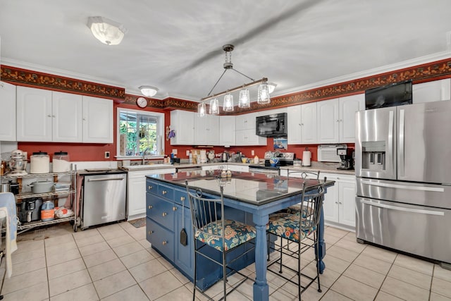 kitchen with stainless steel appliances, white cabinets, and a kitchen island