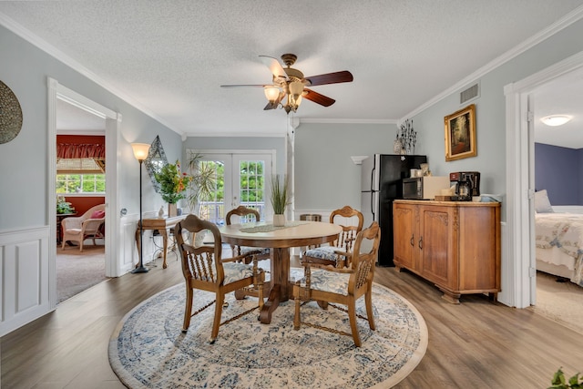 dining area with plenty of natural light, light hardwood / wood-style floors, and french doors