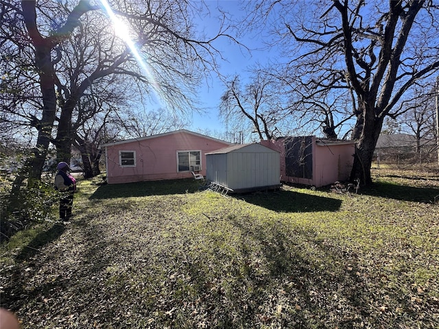 exterior space featuring a yard and a shed