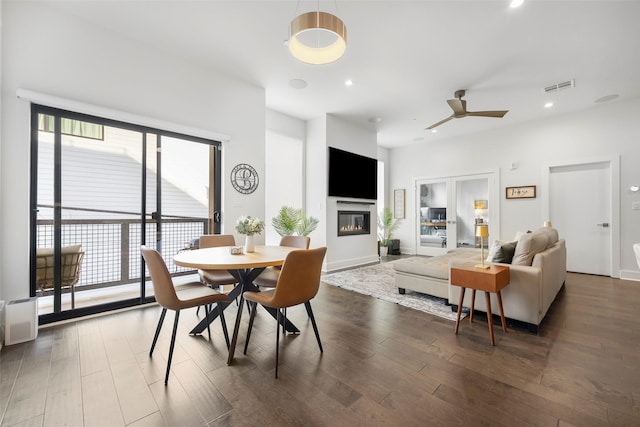 dining room with dark hardwood / wood-style flooring, ceiling fan, and a healthy amount of sunlight