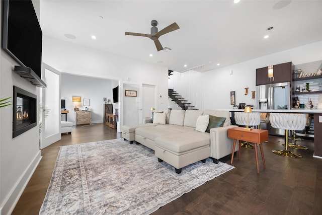 living room featuring dark hardwood / wood-style floors and ceiling fan