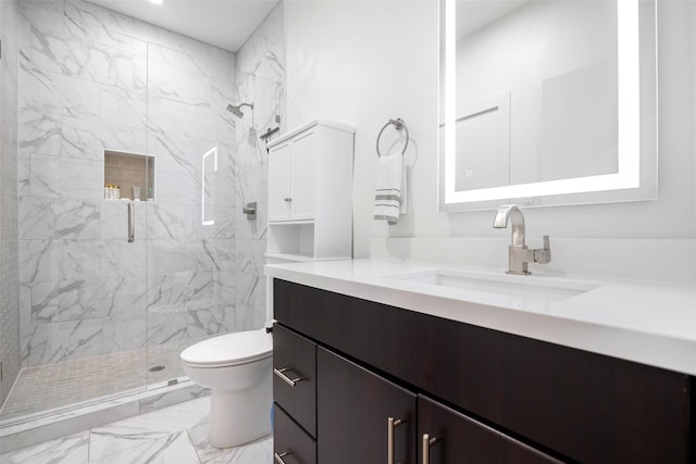 bathroom with vanity, toilet, and a shower with shower door